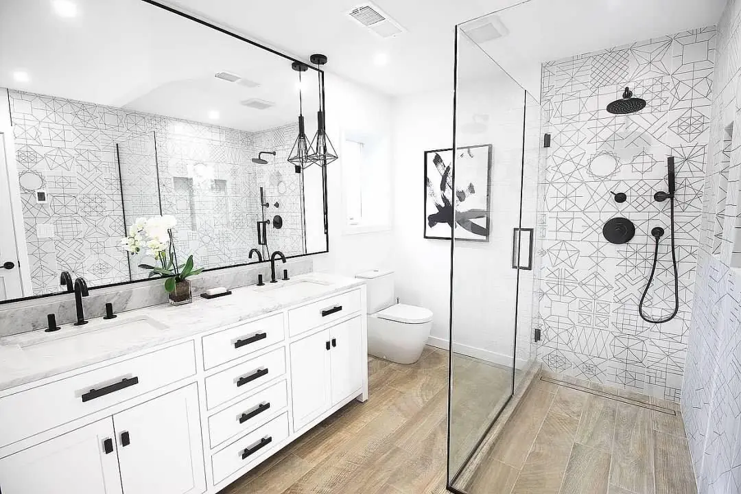 Bathroom renovation with graphic patterned floor tile and glass shower